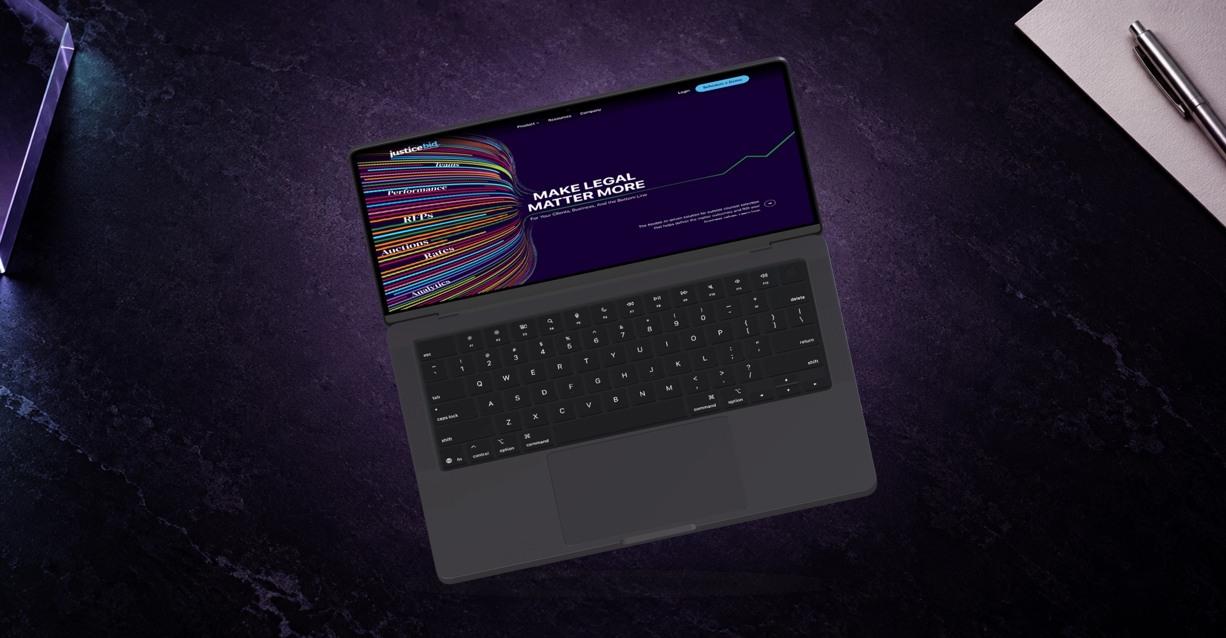JusticeBid’s colorful legal technology homepage on a dark MacBook viewed from above on a violet desk